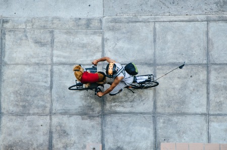 Man with his dog in the front of his bicycle, view from aboveの写真素材