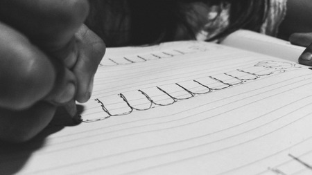 Close up of girls hands writing
