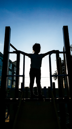 lovely little girl on a childrens slide.の写真素材