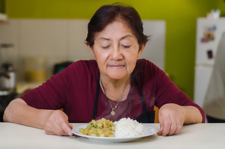 Closeup of moms hands holding a plate, concept of homemade foodの写真素材
