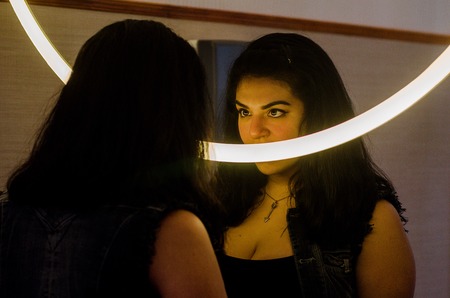 Sexy chubby woman putting on makeup, makeup in front of the mirrorの写真素材