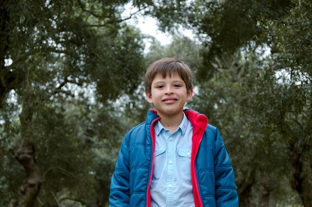 Close up portrait of an attractive and cheerful blond hair teenager in the parkの写真素材