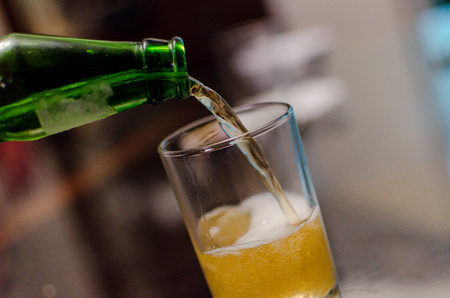 Waiter pouring beer, glass of a cold drink , festival of beer, Oktoberfest autumn holidayの写真素材
