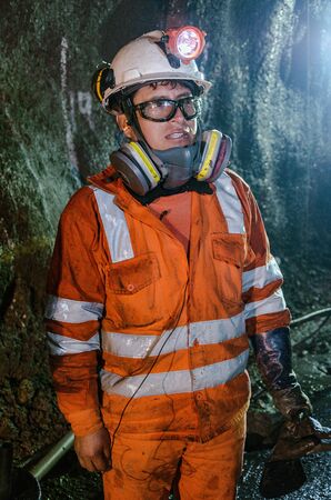 Cerro de Pasco, Peru - July 14th 2017: Miner in the mine. Miner inside the mine well uniformed with...