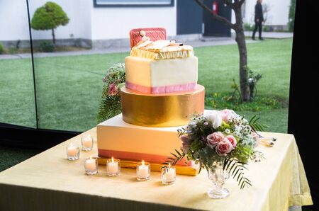 Wedding bride and groom couple doll in funny action at the wedding cake, boyfriends lying tired in bedの写真素材