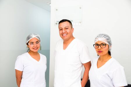Portrait of three doctors smiling at the cameraの写真素材