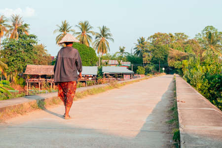 People walking on the historical bridge between Don Det and Don Khon. built by the French on the Mekong river in Laosの写真素材