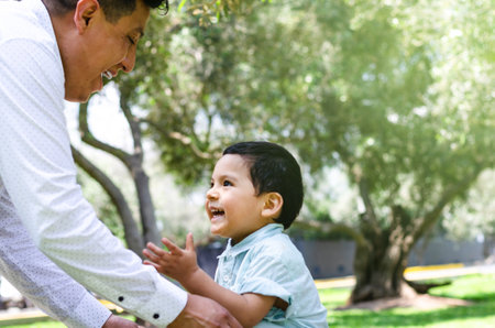 Father and son enjoying in the park, concept for fathers day.の写真素材