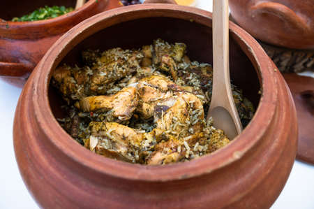 Peruvian cuisine: Chicken and rice called arroz con pollo in a clay pot.の素材 [FY310188006987]