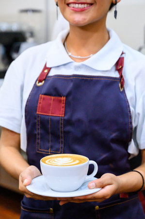 Latin Woman Barista Working Holding Coffee Cup At Cafe Working woman small business owner or sme concept.の写真素材