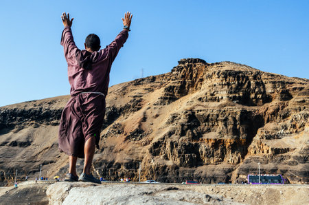 Man celebrating on a mountain overlookの写真素材