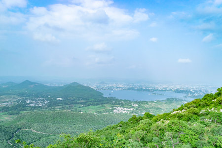 Breathtaking panorama of udaipur city overlooking lush green hills and lake pichola in india