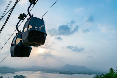Cable cars moving over lake pichola in udaipur indiaの写真素材