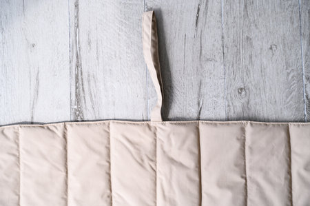 Beige pet friendly padded mat lying on wooden floorの写真素材