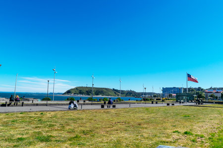 People relaxing in a public park overlooking the chilean coastlineの写真素材