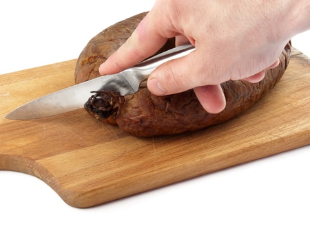 hands cutting sausage close upの写真素材