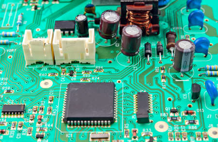 green electrical circuit board with conductors and transistors