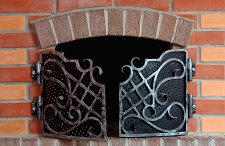 Close up of brick fireplace with an iron gateの写真素材