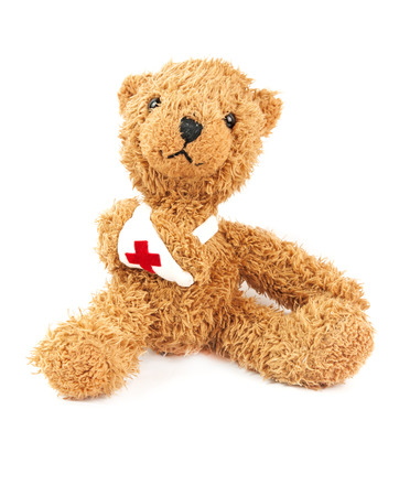 cute teddy bear with a broken arm in a slingの写真素材