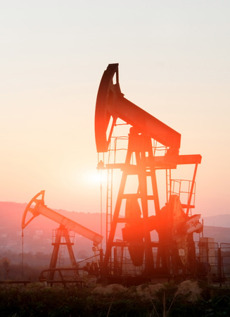 oil pump on orange sunsetの写真素材