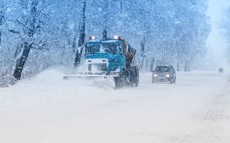 snow plow doing snow removal during blizzardの写真素材