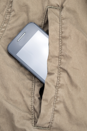 smartphone in pocket jacket. A close upの写真素材