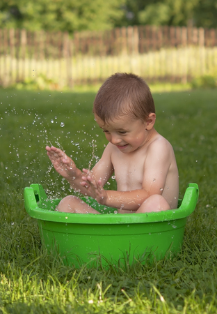 boy bathing in the garden. A close up