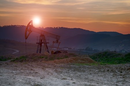 oil pump on orange sunsetの写真素材