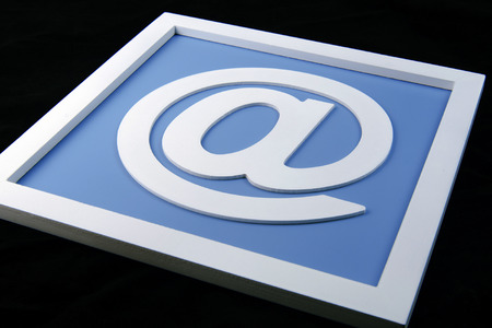 white e-mail sign isolated on black backgroundの写真素材