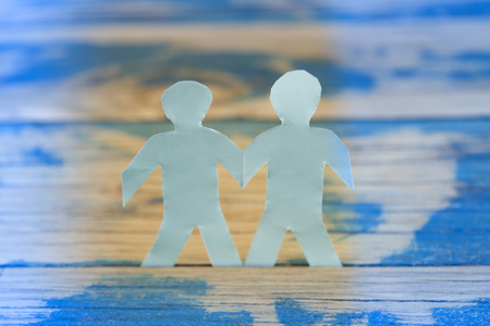 blue paper people on wooden backgroundの写真素材