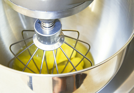 kitchen mixer whisk dough made from egg yolk and flour.の写真素材
