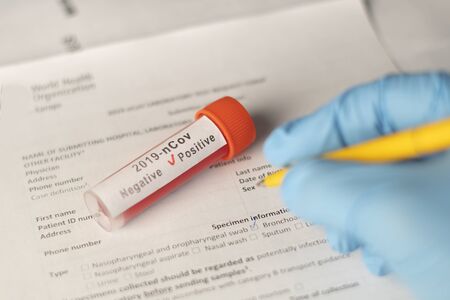 Spread of the coronavirus is documented by a doctor after a positive testの写真素材