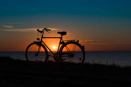 bike silhouette at the sunset near sea