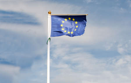 European Union flag flying in front of bright blue skyの写真素材