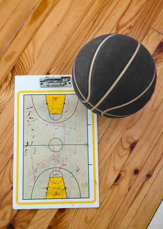 scheme basketball game on clip board paper with marker and wooden table backgroundの写真素材