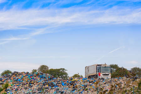 garbage truck unloading at a landfillの写真素材