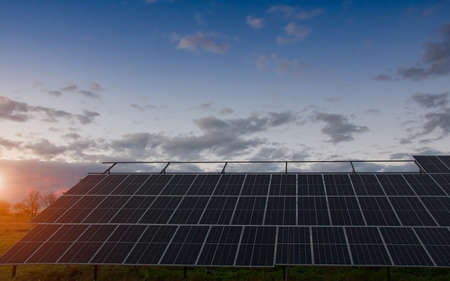 photovoltaic panel with sunset background. Sustainable energy and environmental friends concept.