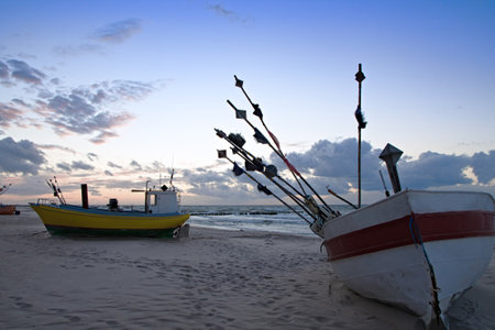 Fishing boat on the beach of the Polish Baltic coast near Rewal. Sunsetの写真素材