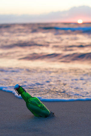 Message in the bottle washed ashore against soft waves. dream ideas conceptの写真素材