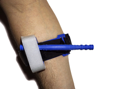 Applied tourniquet on a hand to prevent bleeding during the first aidの写真素材