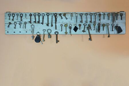 Vintage wooden green panel of many different old keysの写真素材