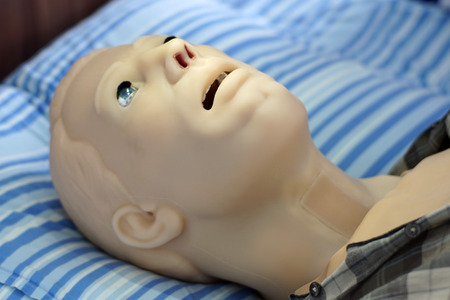 Robotic character with medic aim / Futuristic patient works as a patient during medical simulation trainings, for examination and treatment by students or physicians in an innovative educational process.の写真素材