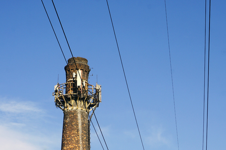old brick factory chimney against the skyの写真素材