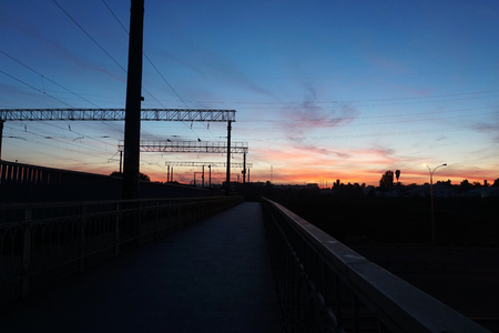 sunset at the train stop with beautiful deep blue sky and red clouds.の写真素材