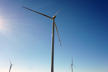Eco power, wind turbines with blue sky. wind turbine for alternative electricity.renewable electric farm with sustainable eco-friendly technology using wind energy rotation for wind turbines renewableの写真素材