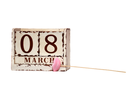 8 March Happy Women's Day with wooden block calendar and pink lips on a stick, isolated on whiteの写真素材