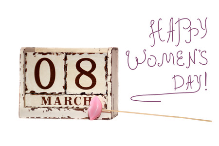 8 March sign Happy Women's Day with wooden block calendar and pink lips on a stickの写真素材