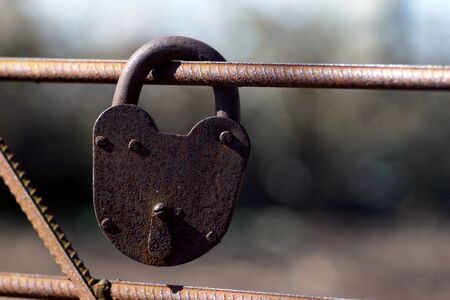 Rusty padlock. Old rusty lock with a key on a nature background, closeupの写真素材
