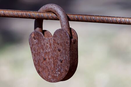 Rusty padlock. Old rusty lock with a key on a nature background, closeupの写真素材
