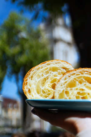 Cutaway Fresh homemade unfilled croissants for breakfast with city background. Vertical